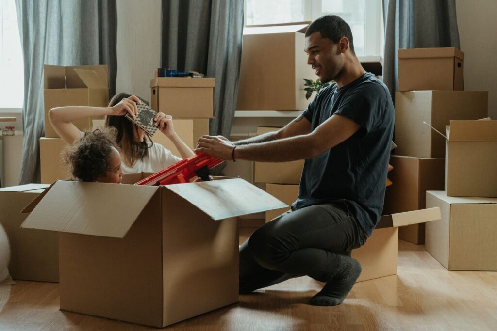 A family creatively makes unpacking fun with playful activities during their move into a new home.